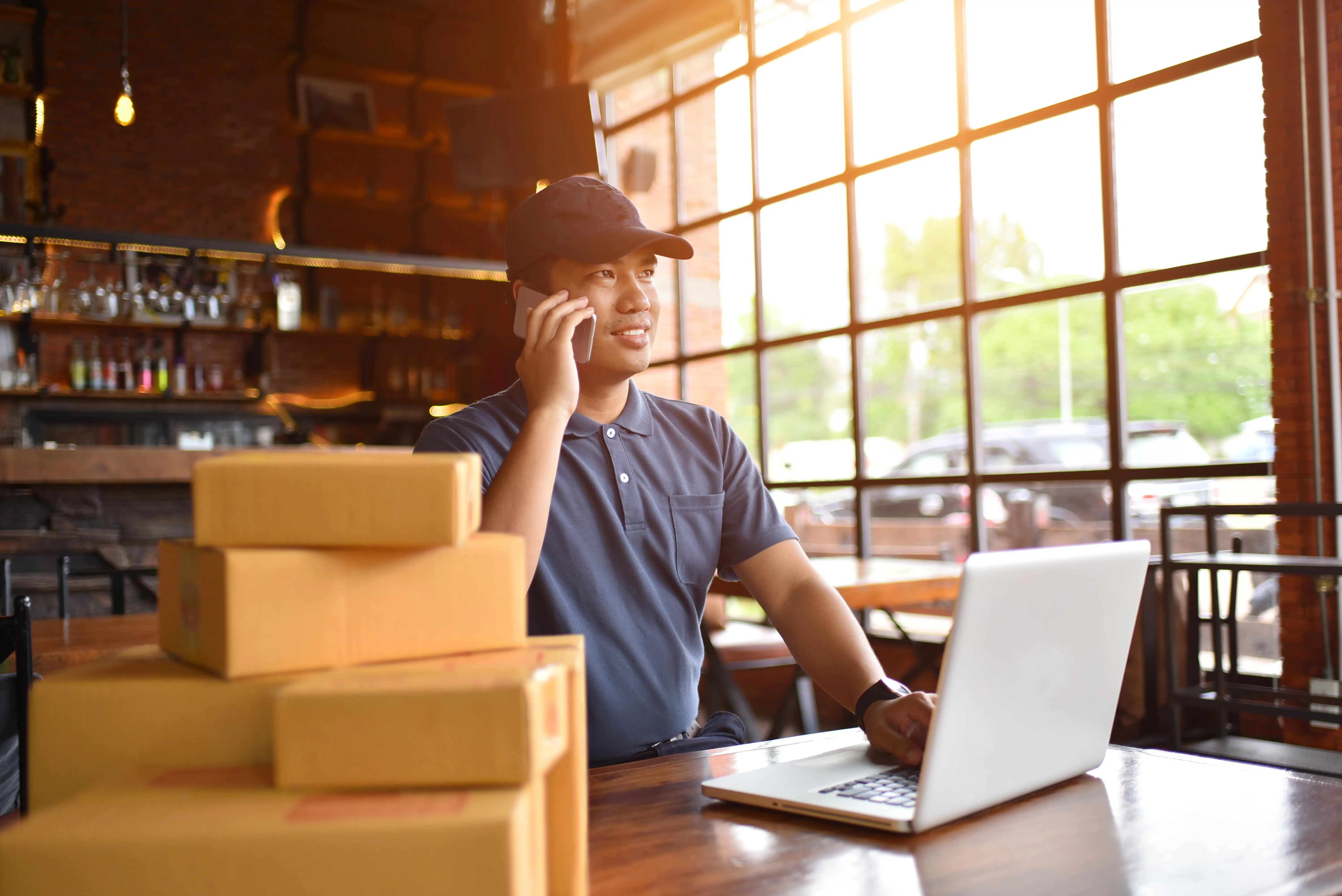 Young business man organising a self drive van hire with hirefleet to deliver packages to customers.