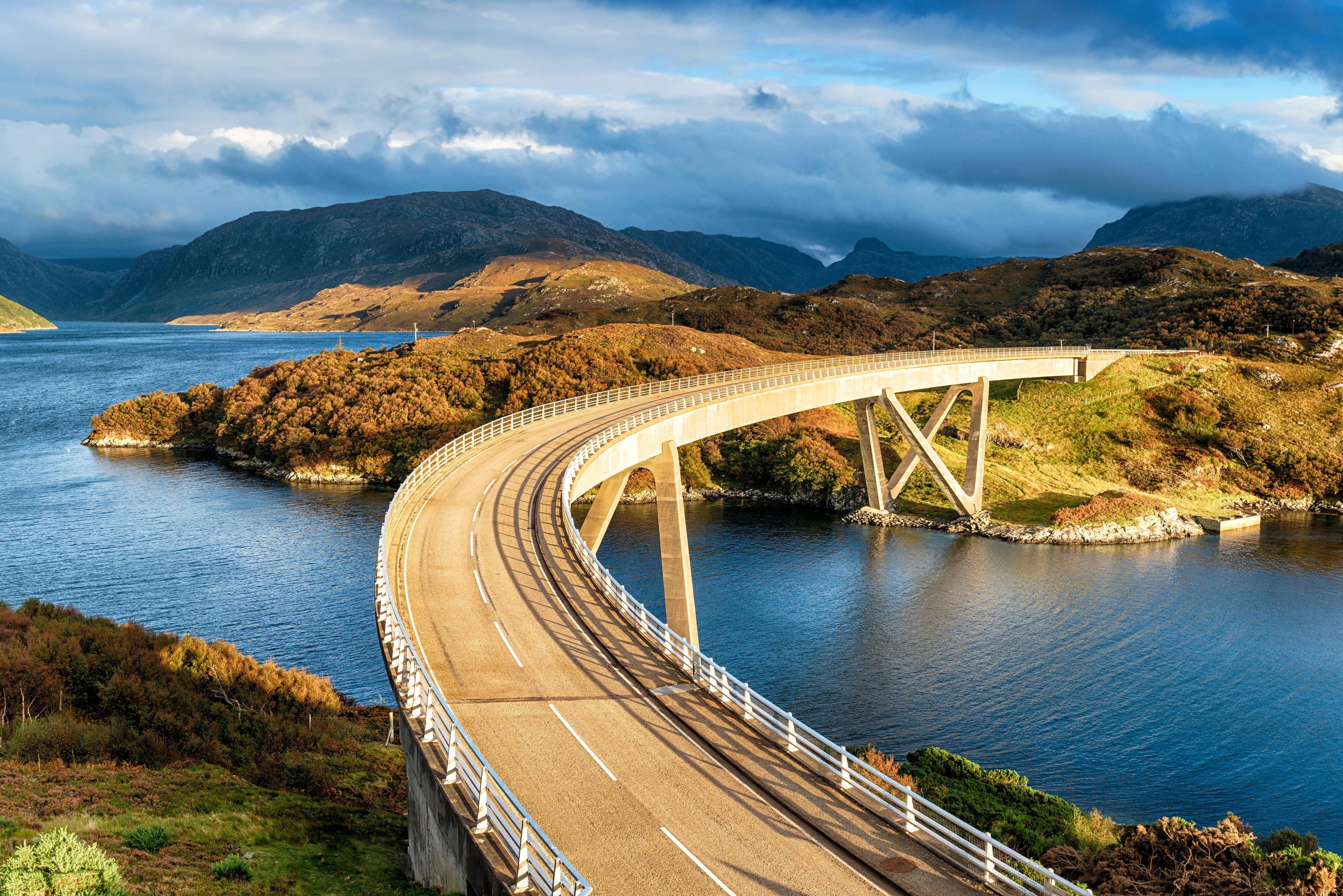The curved Kylesku Bridge in the Highlands of Scotland, part of the North Coast 500 and the perfect road trip 2025.
