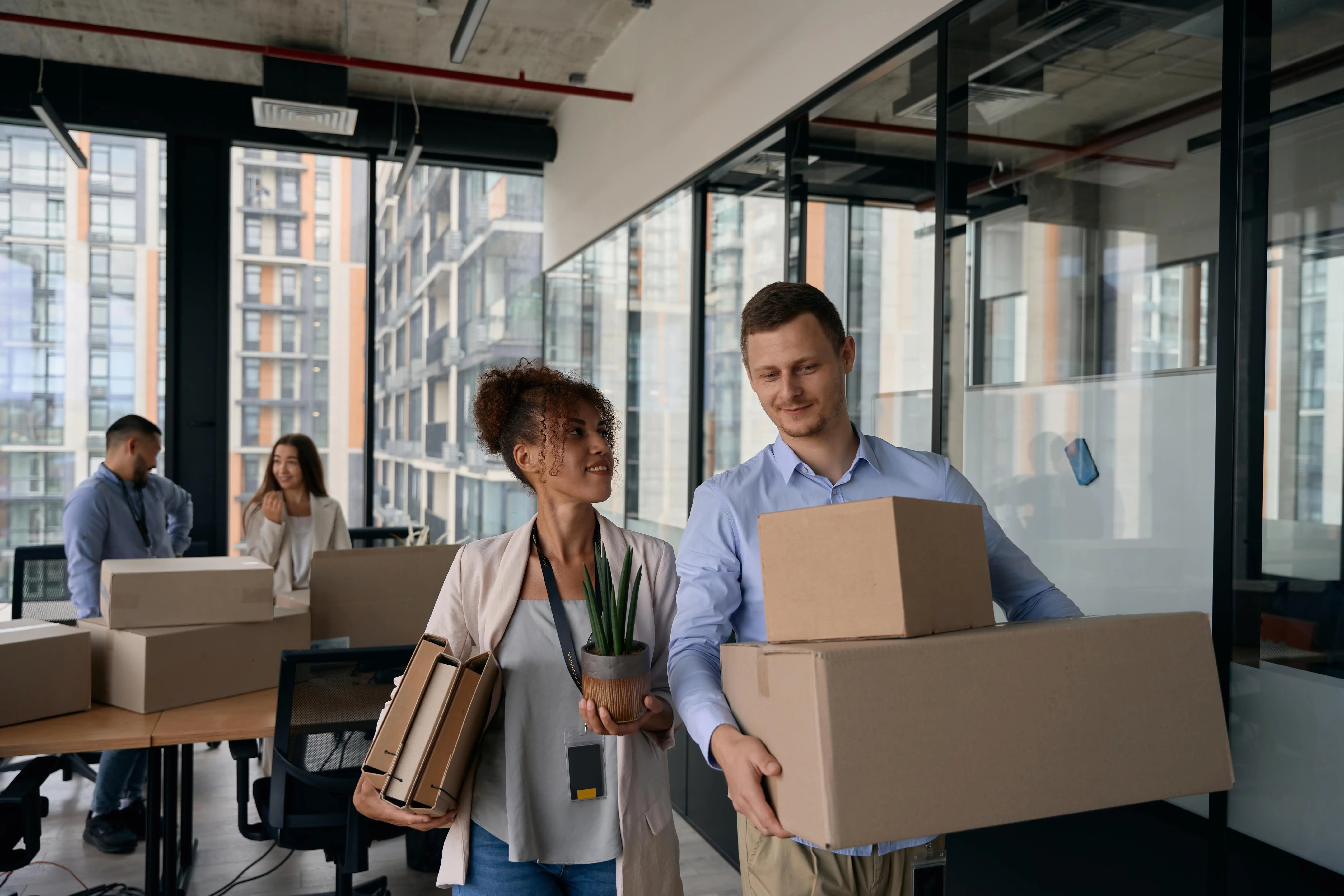 Young office workers preparing for an office relocation with hirefleet self drive van hire.
